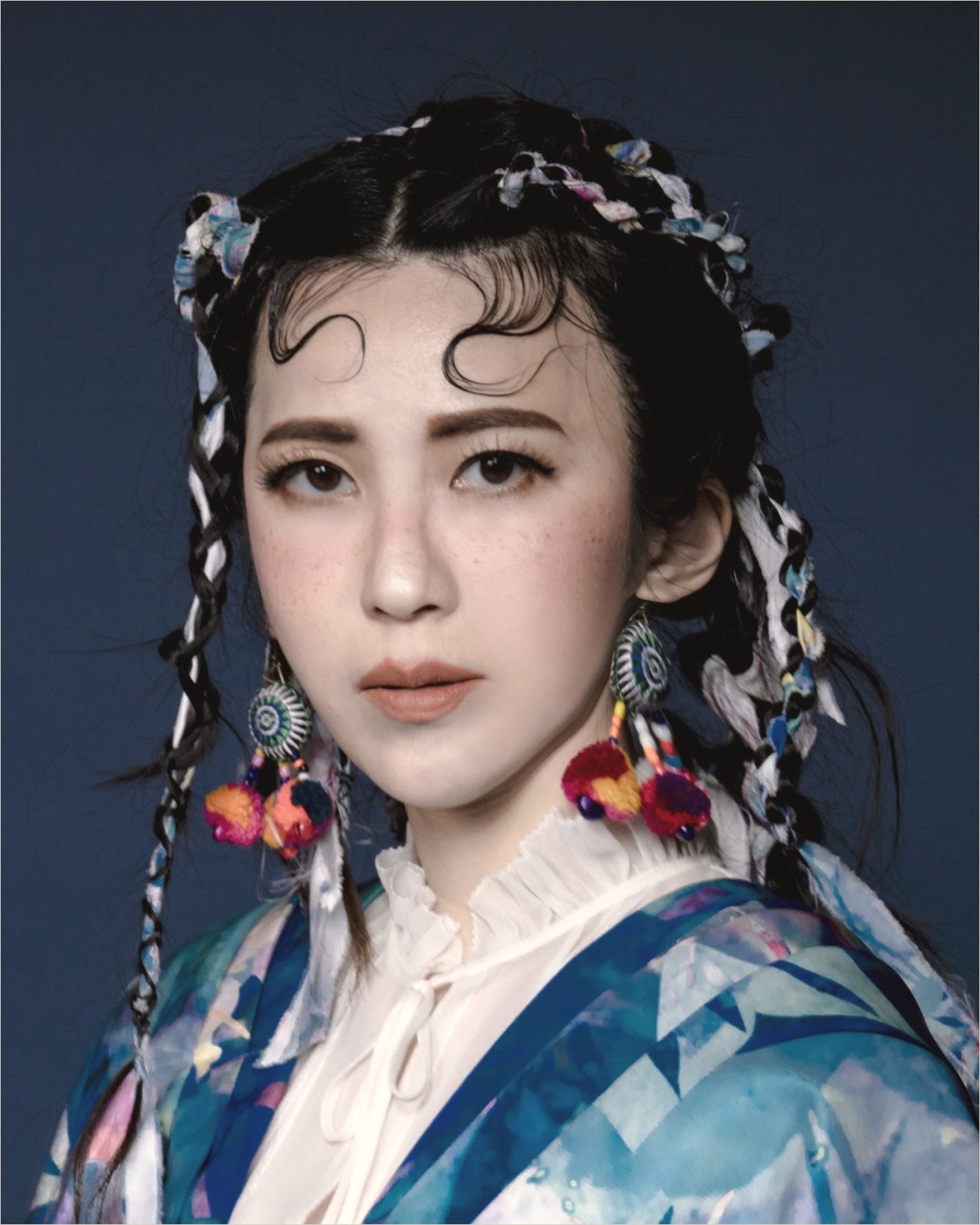 Ku Chi-Chun in a traditional headdress and a blue garment