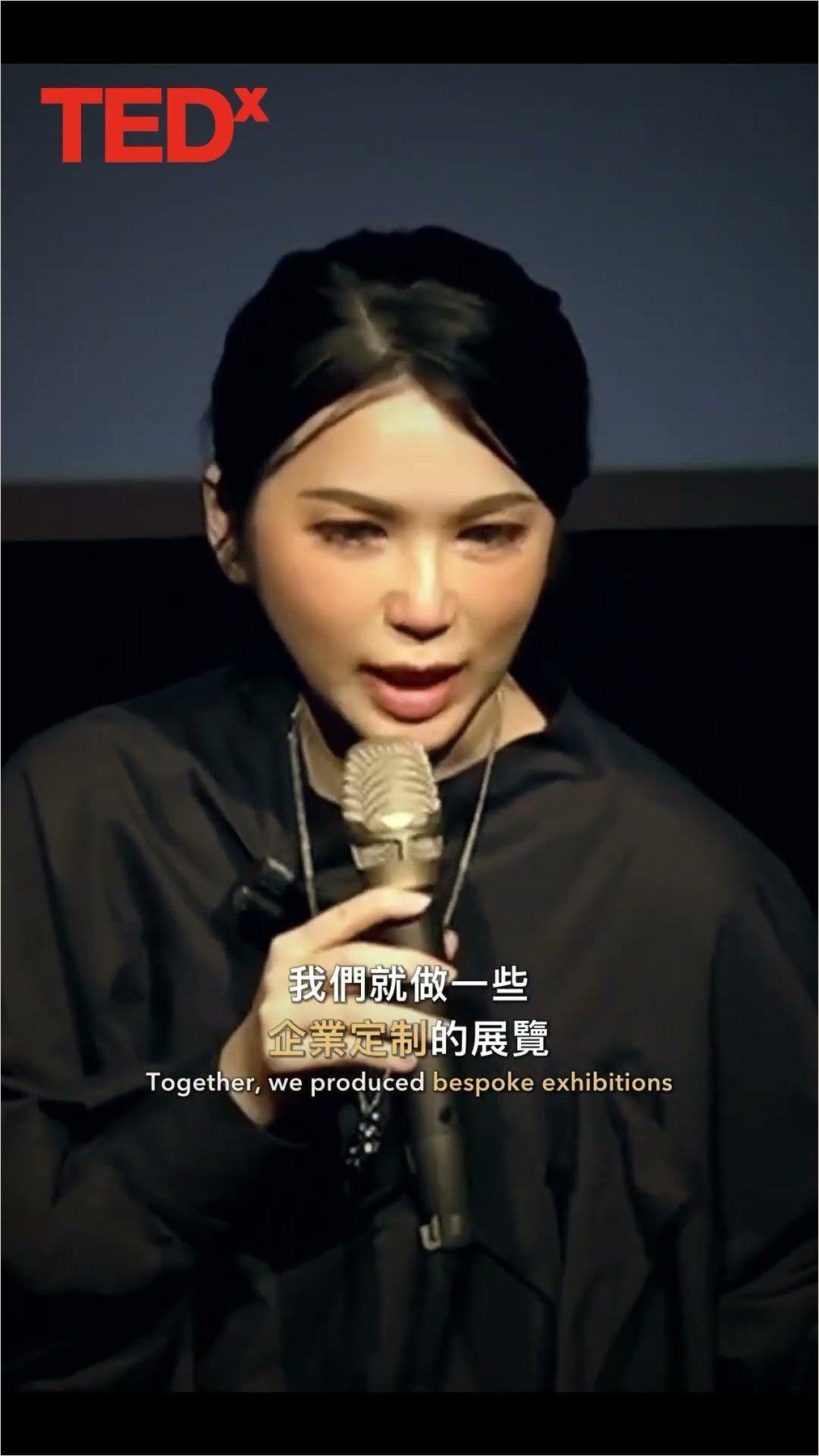 Cover of a TEDx short: Ku Chi-Chun speaking into a microphone on a dark stage, captioned Together, we produced bespoke exhibitions